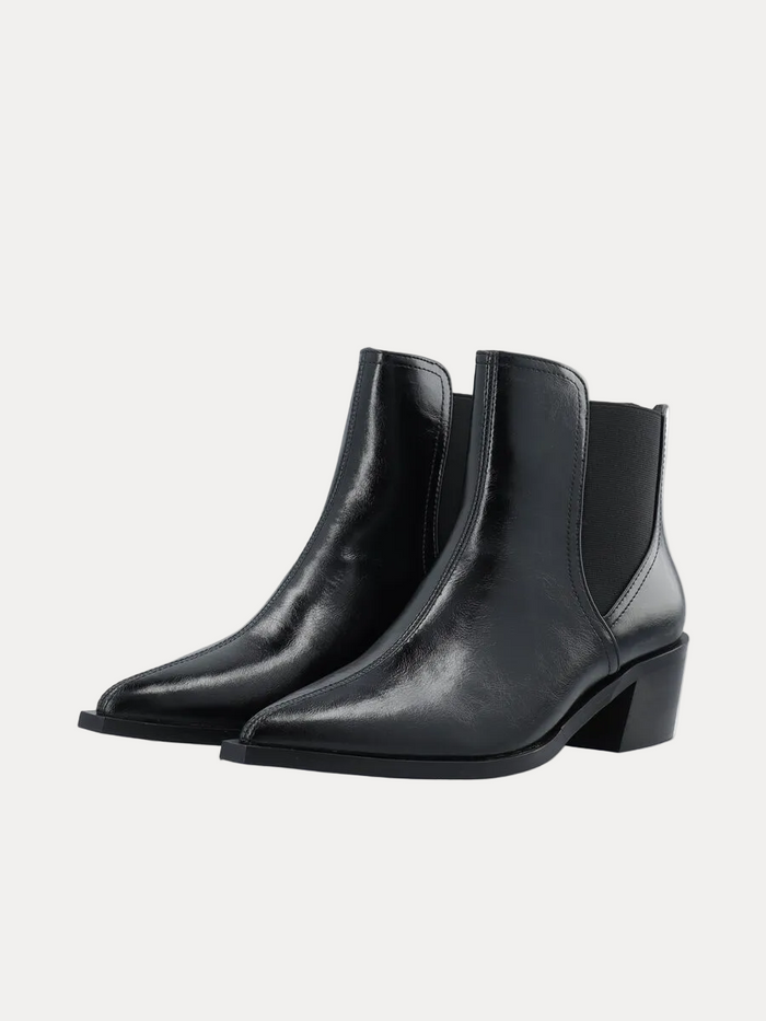 Pair of black leather ankle boots on a white background