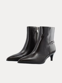 A pair of black leather ankle boots with pointed toes, low kitten heels, side zippers, and a small silver buckle detail on the outer side, shown against a plain white background.