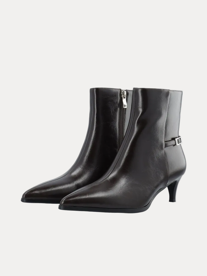 A pair of black leather ankle boots with pointed toes, low kitten heels, side zippers, and a small silver buckle detail on the outer side, shown against a plain white background.