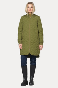A woman modeling a long olive green quilted coat with a full front zipper, paired with dark blue jeans and black rain boots, against a plain off-white background.