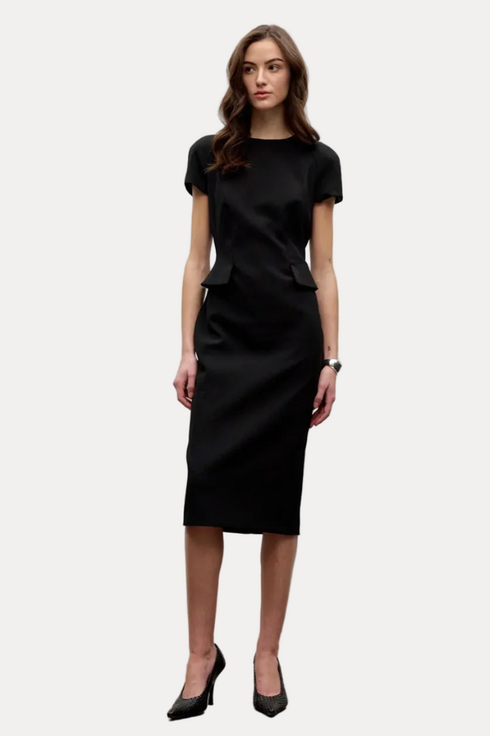 Woman wearing a black dress against a white background