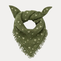 An olive green knit pet bandana scarf with white heart and swirl patterns and fringed edges, styled with two ears knotted on top, shown against a plain white background.