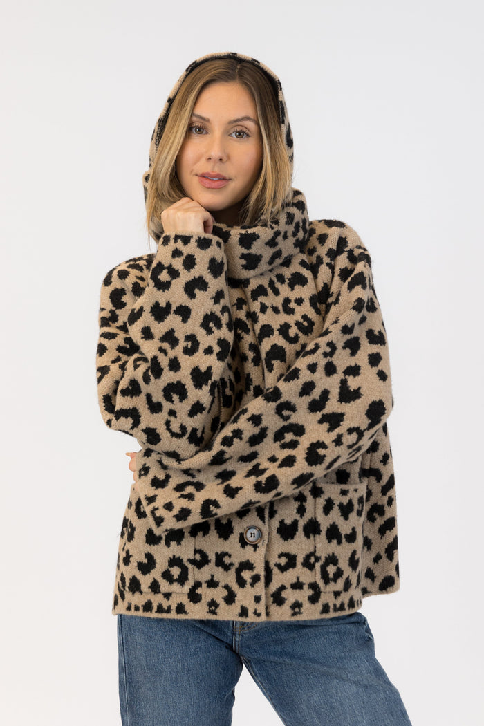 Woman wearing a leopard print coat on a white background