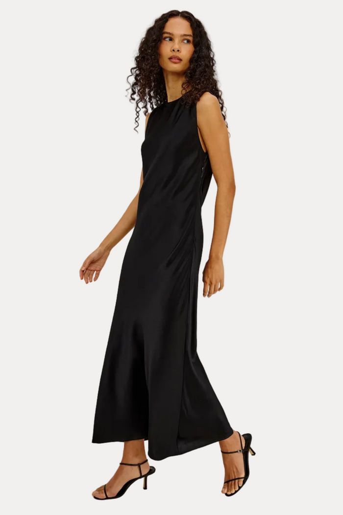 Woman wearing a black sleeveless dress on a white background