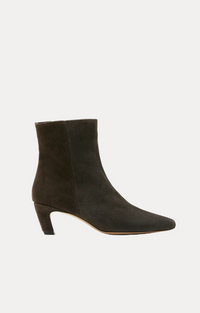 A dark brown suede ankle boot with a pointed toe and a low block heel, shown from a side profile on a white background.