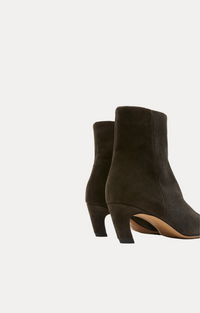 A pair of dark brown suede ankle boots with block heels, shown from a rear three-quarter angle on a plain white background.