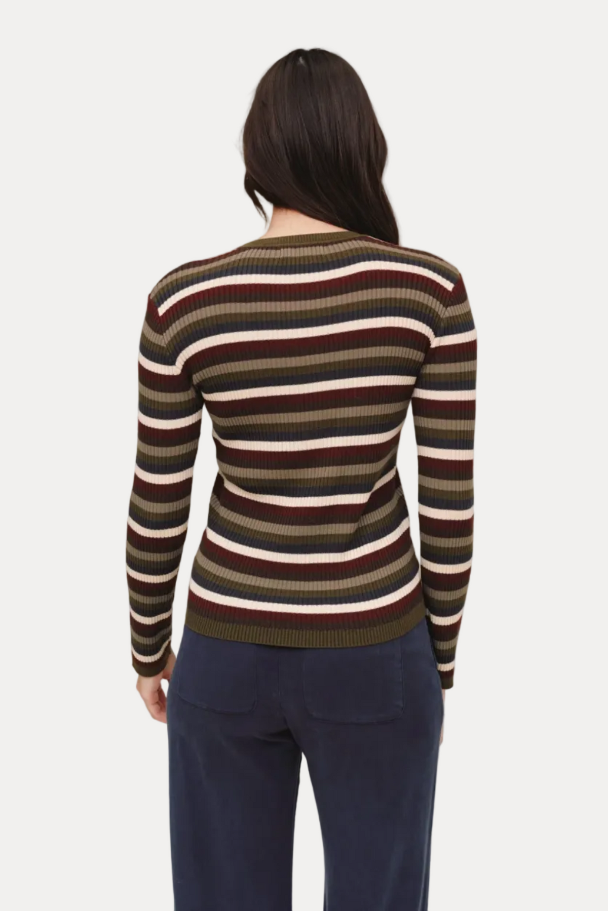 Person wearing a striped sweater with a neutral background